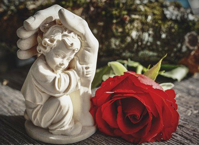 Angel sculpture with rose